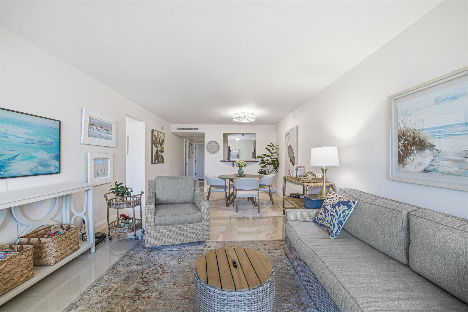 An oval swimming pool with a turquoise interior sits on a paved patio with palm trees — 6 Royal Palm Way # 211, Boca Raton FL 33432, BOCA RATON, FL