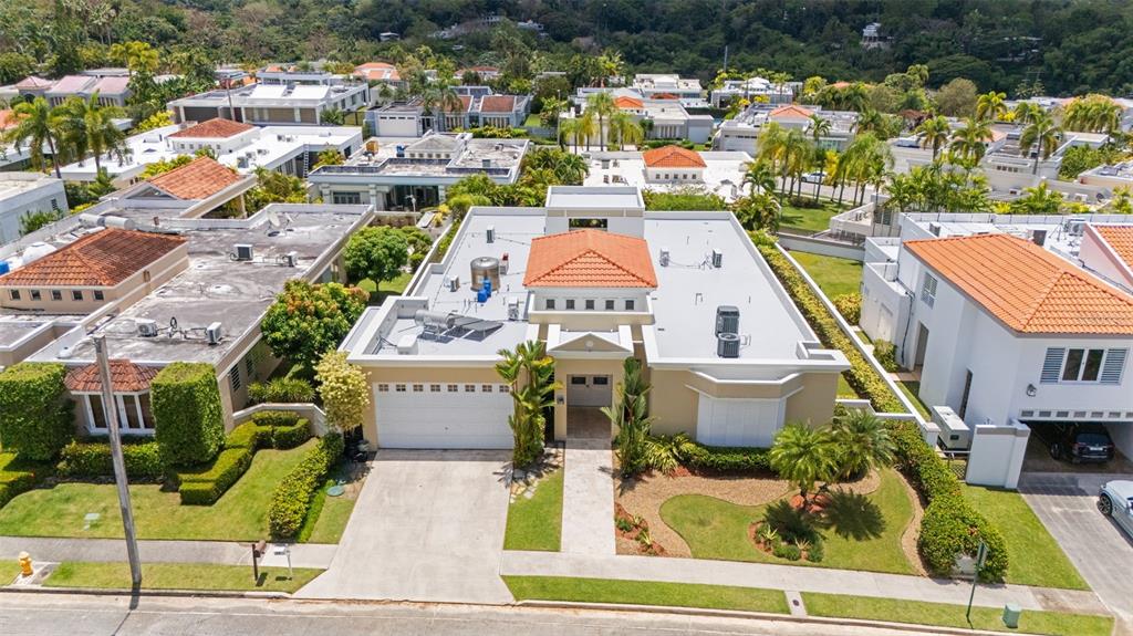 An aerial view of a single-story house with a terracotta roof and a concrete driveway — PASEO SAN JUAN C-8 CALLE ROGATIVA, SAN JUAN, PR