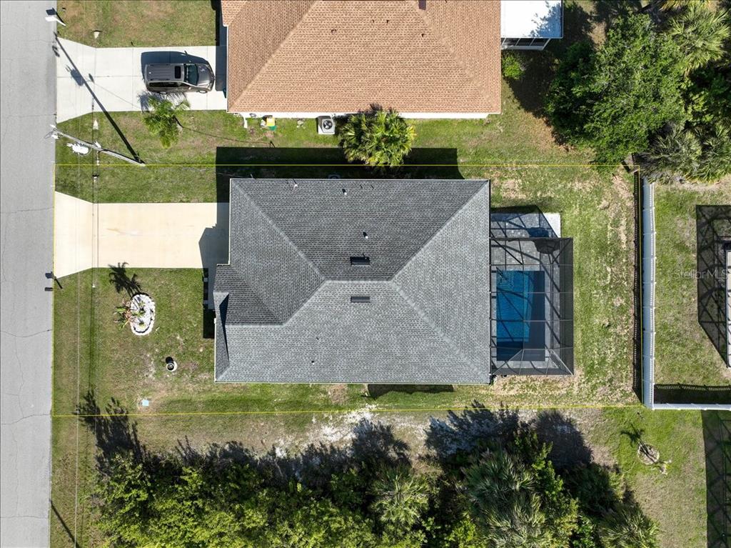 An aerial view shows a house with a gray roof, a screened-in pool, and driveway — 138 SUNNY WAY, ROTONDA WEST, FL