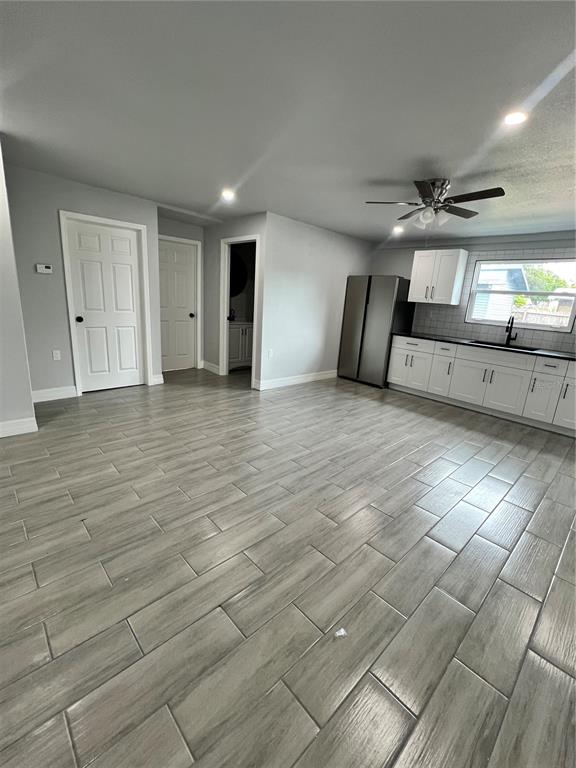 A kitchen with white cabinets, stainless steel appliances, and light gray wood-look tile flooring — 2309 21ST AVENUE W, BRADENTON, FL