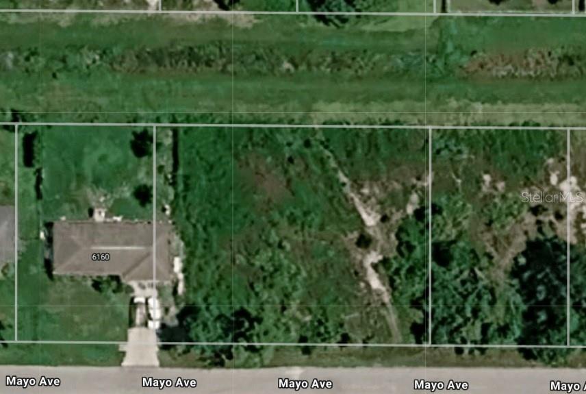This aerial map shows a residential lot with an existing house next to vacant land — MAYO AVENUE, NORTH PORT, FL