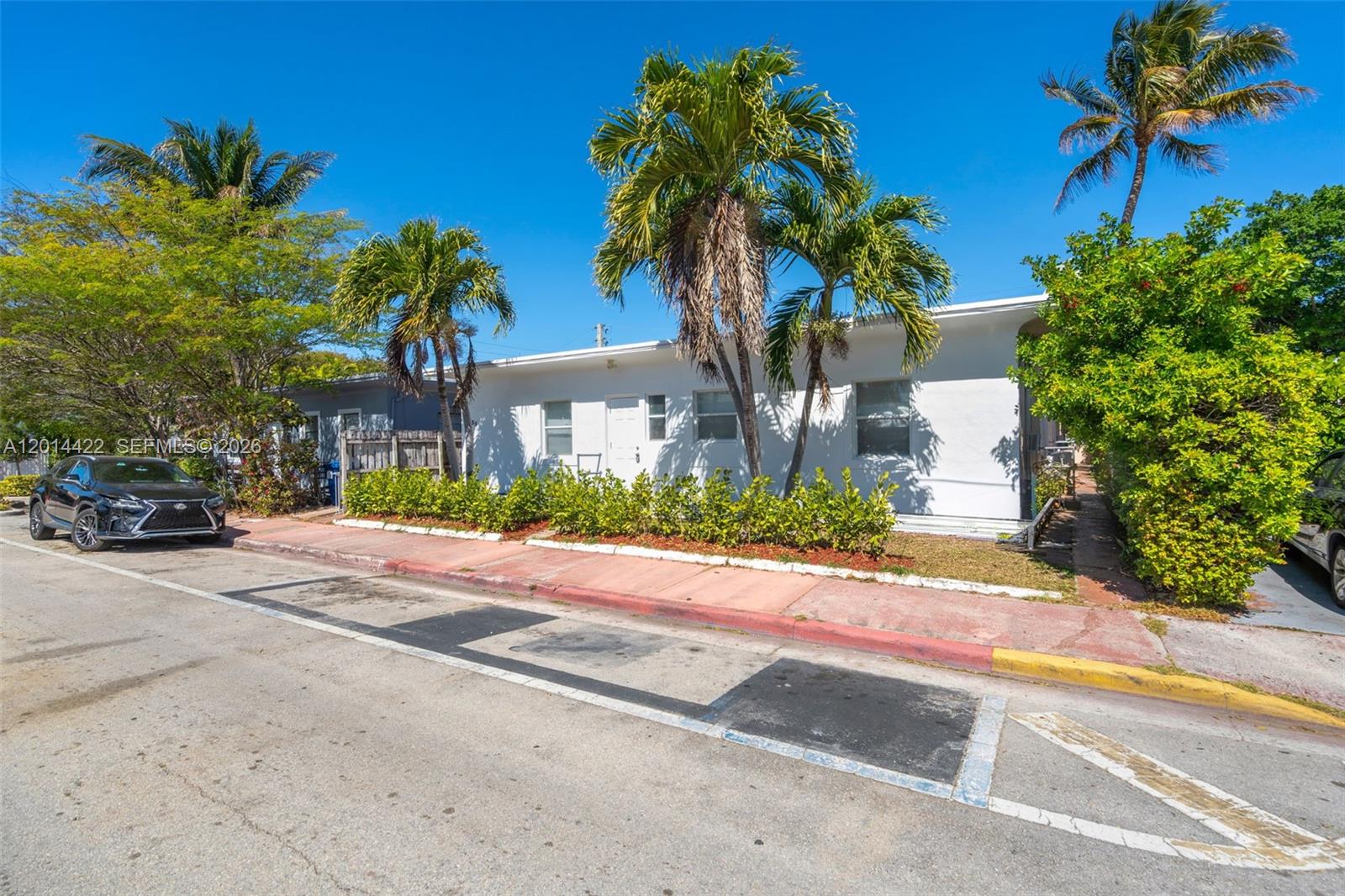 A white single-story house with palm trees and a parked car in front — 835 83rd St, Miami Beach FL 33141, MIAMI BEACH, FL