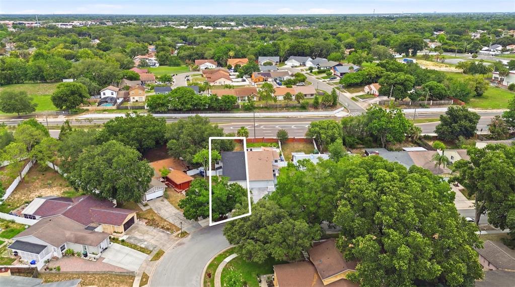 An aerial view shows a residential house highlighted by a white outline on a street — 7215 HARBOR HEIGHTS CIRCLE, ORLANDO, FL