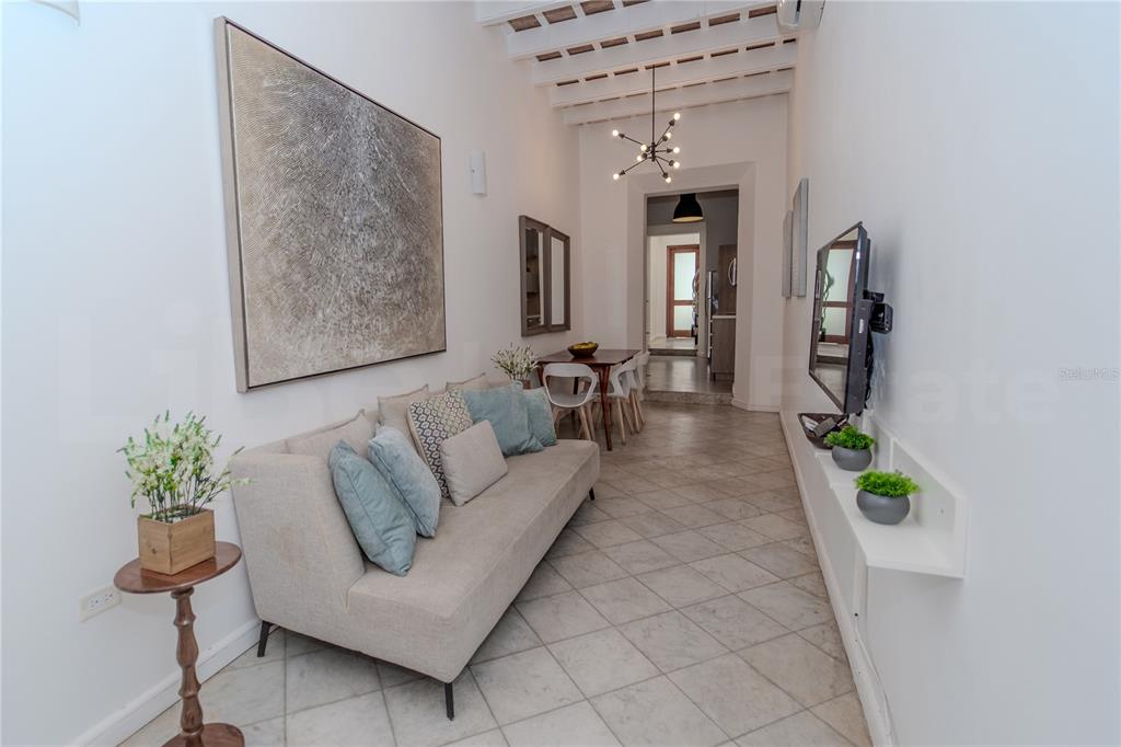 A living room features a beige sofa, a dining area, and a tiled floor — 152 SOL STREET, OLD SAN JUAN, PR