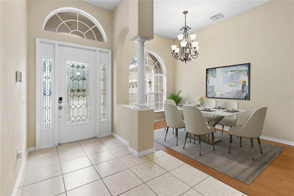 A tiled entryway leads to a dining area with a chandelier and a white door — 513 PARKSIDE POINTE BOULEVARD, APOPKA, FL