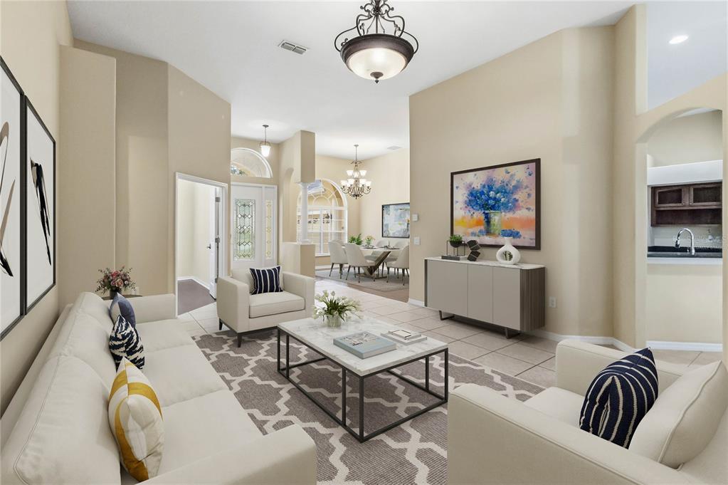 A living room with a sofa, armchairs, coffee table, and a dining area in the background — 513 PARKSIDE POINTE BOULEVARD, APOPKA, FL