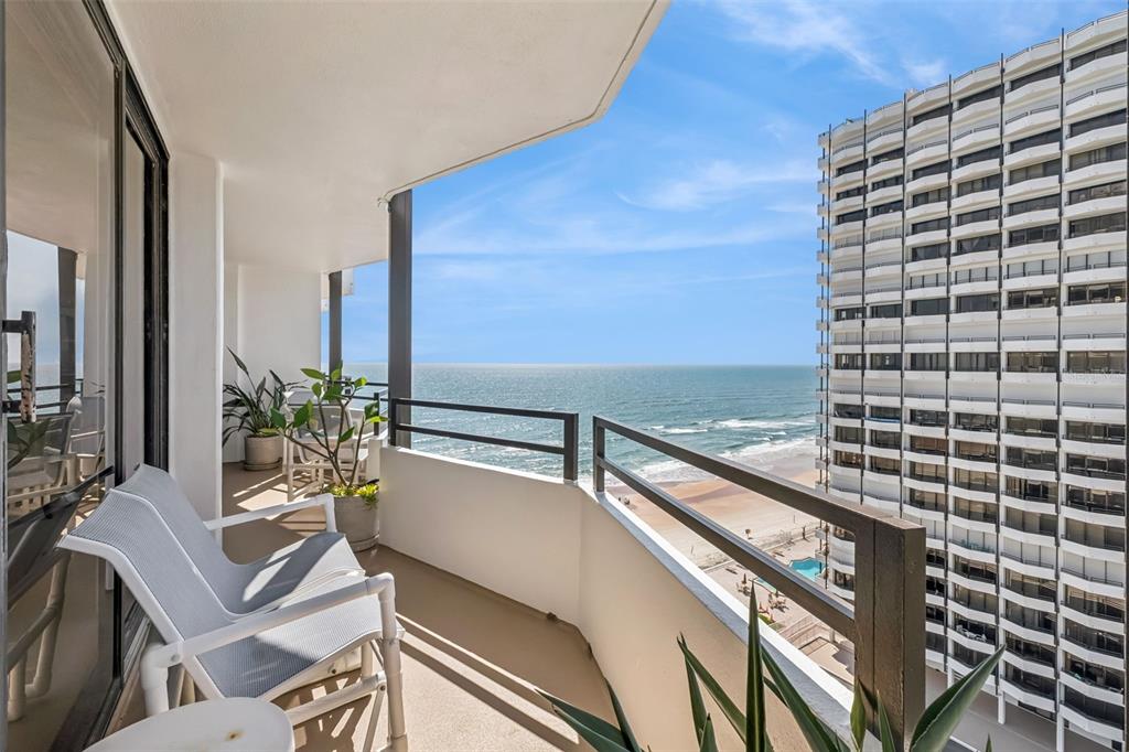 An aerial view shows three tall beachfront residential towers with a swimming pool and parking — 2900 N ATLANTIC AVENUE UNIT 1106, DAYTONA BEACH, FL