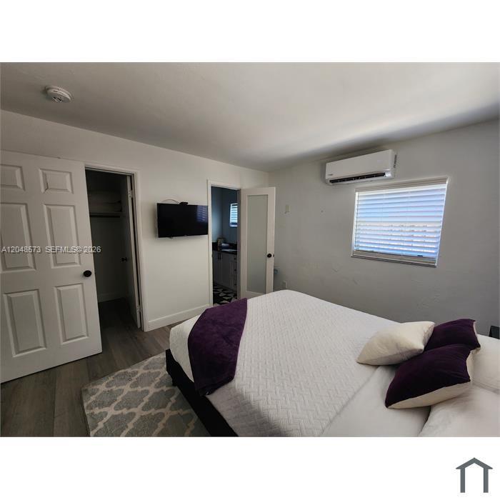 A white closet interior features a shelf and a rod with two hangers — 2032 NE 26th St # 3, Wilton Manors FL 33305, WILTON MANORS, FL