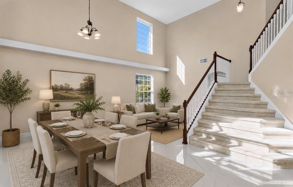 A dining area and living room with high ceilings, large windows, and a carpeted staircase — 2508 BROSS DRIVE, ST CLOUD, FL