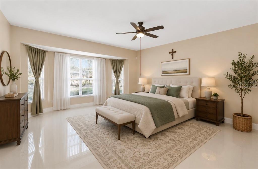 A bedroom features a bed with a green runner, a ceiling fan, and large windows — 2508 BROSS DRIVE, ST CLOUD, FL