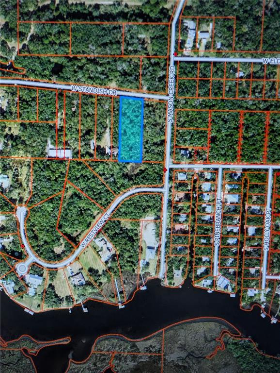 This aerial map shows a rectangular parcel of land highlighted in blue near a waterway — 12148 W STANDISH DRIVE, HOMOSASSA, FL