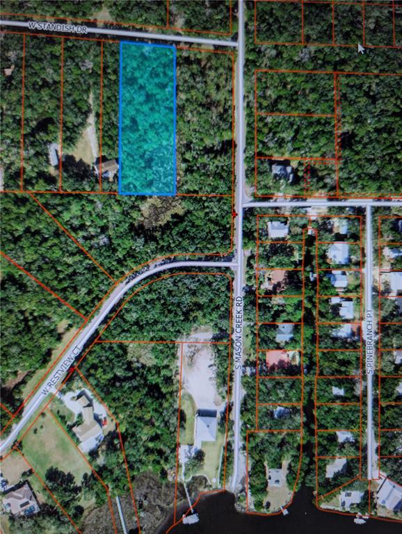 This is an aerial map showing a highlighted vacant lot among residential properties and trees — 12148 W STANDISH DRIVE, HOMOSASSA, FL