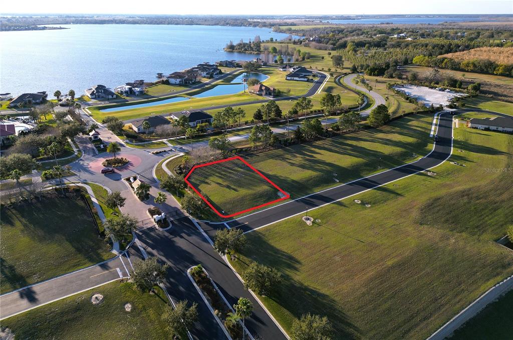 An aerial view shows a vacant residential lot outlined in red within a suburban community — 508 BONAMIA AVENUE, LAKE ALFRED, FL