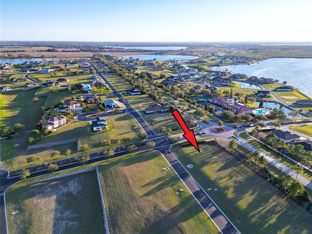 An aerial view shows a vacant residential lot marked by a red arrow — 508 BONAMIA AVENUE, LAKE ALFRED, FL