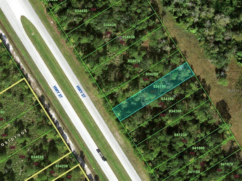 This is an aerial map showing a highlighted parcel of land next to a highway — US 27 HIGHWAY UNIT 517, FROSTPROOF, FL