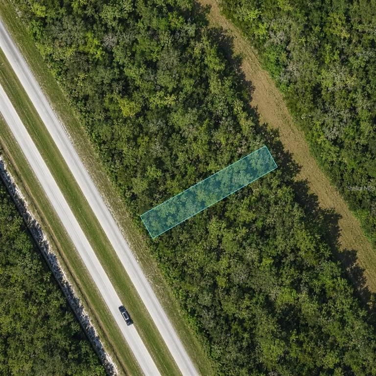 An aerial view shows a rectangular highlighted plot of land adjacent to a paved road — US 27 HIGHWAY UNIT 517, FROSTPROOF, FL