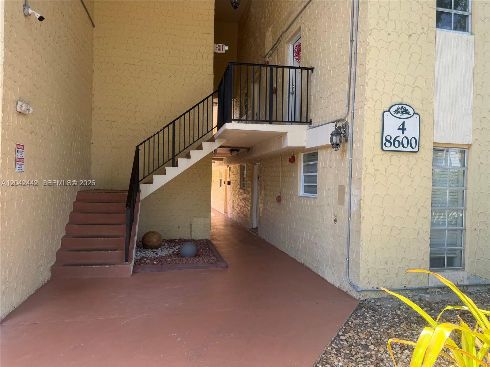 An exterior view of a two-story apartment building with a staircase and walkway — 8600 SW 109th Ave # 231, Miami FL 33173, MIAMI, FL