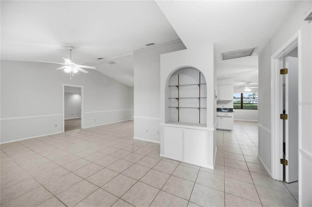 An interior view of a living area with tile floors, an arched display niche, and cabinetry — 2221 MAURITANIA ROAD, PUNTA GORDA, FL
