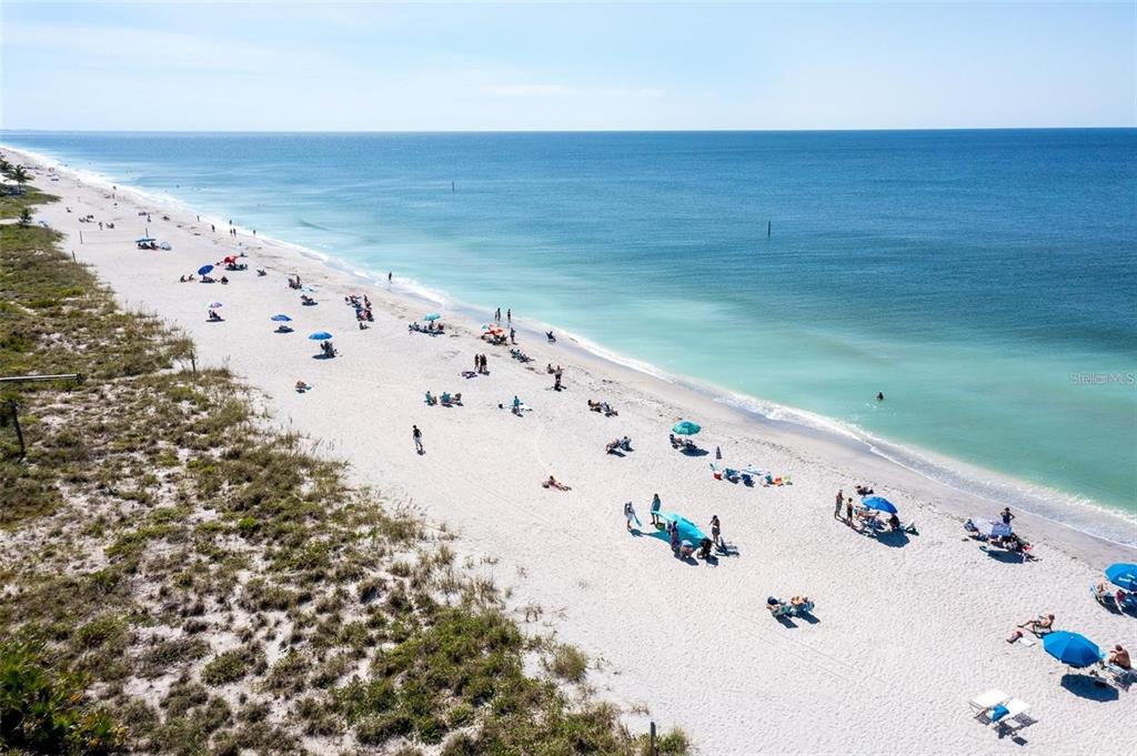 An aerial view of a sandy beach with people, umbrellas, and the ocean — 13362 CHAMBERLAIN BOULEVARD, PORT CHARLOTTE, FL