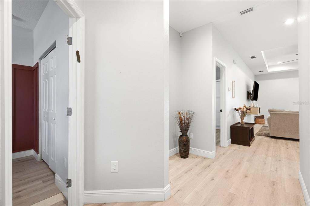An open-concept living room and kitchen featuring a beige sectional, ceiling fan, and stainless appliances — 4102 N 29TH STREET, TAMPA, FL