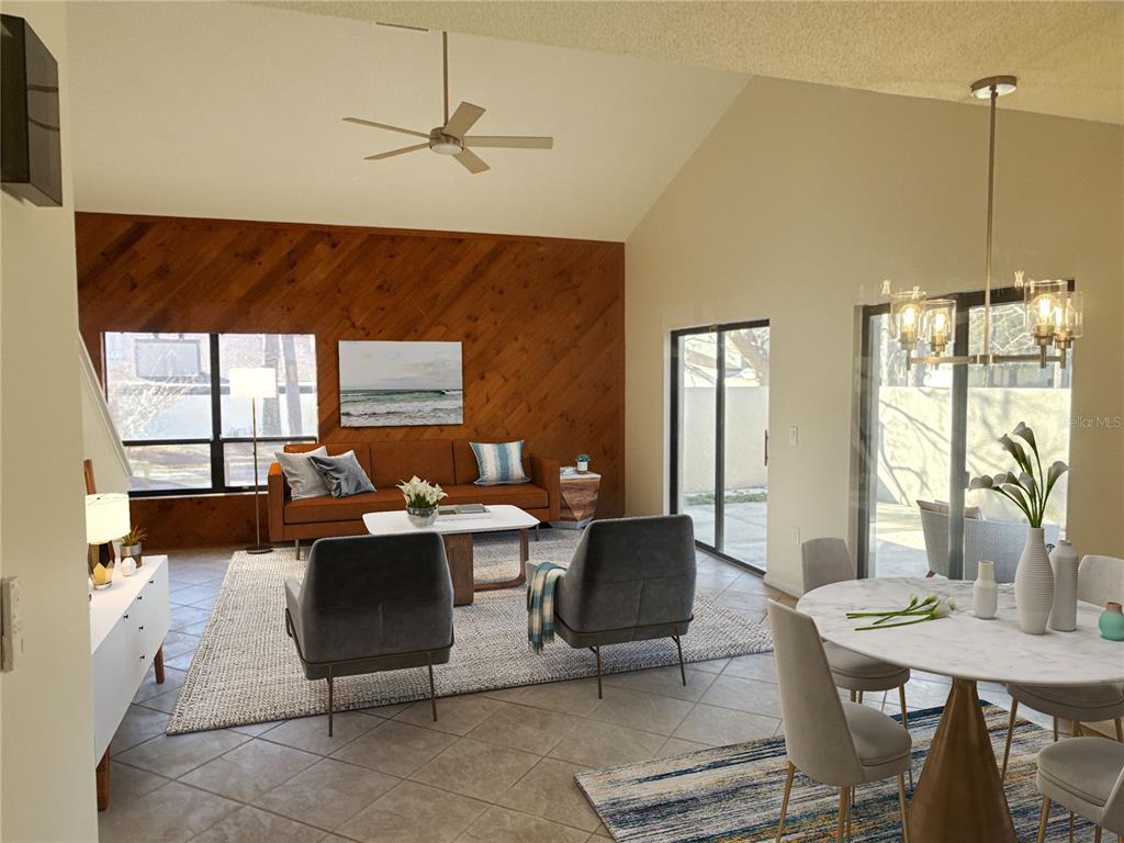 A living and dining area features a vaulted ceiling, wood-paneled wall, and tile flooring — 3808 NE 17TH STREET CIRCLE, OCALA, FL