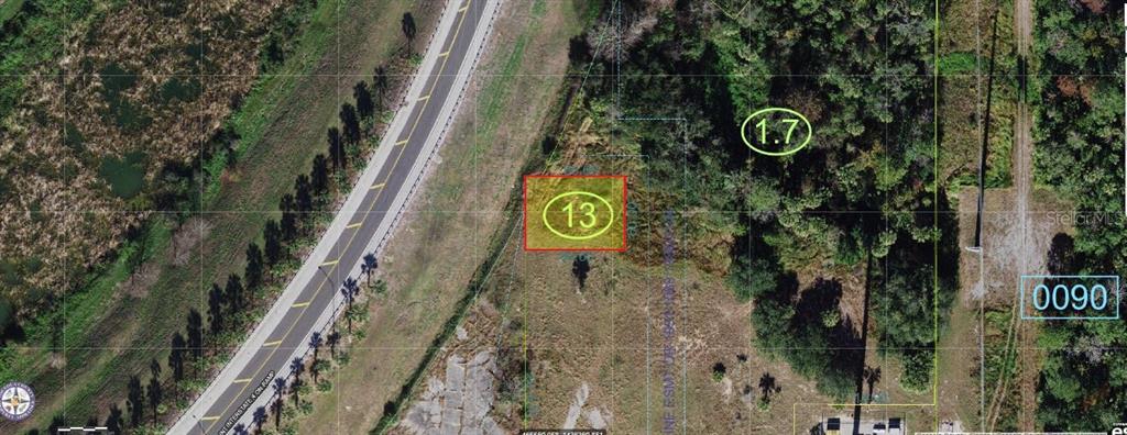 This is an aerial map showing a highlighted rectangular plot of land near a highway — N OLD LAKE WILSON ROAD, KISSIMMEE, FL