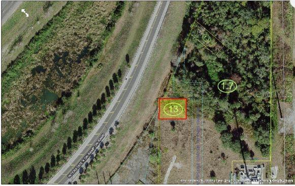 An aerial map view shows a rectangular plot of land highlighted in red near a highway — N OLD LAKE WILSON ROAD, KISSIMMEE, FL