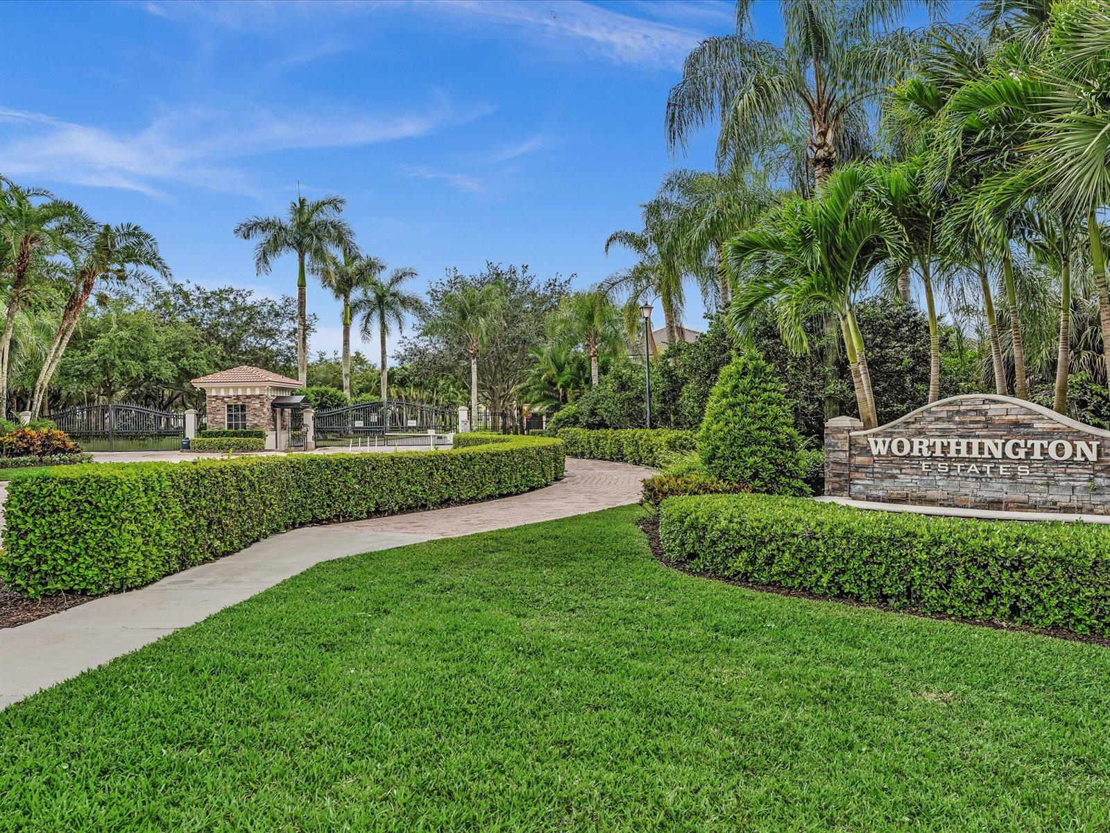 A stone sign for Worthington Estates stands beside a paved driveway leading to a gated entrance — 9286 Nugent Trail, West Palm Beach FL 33411, WEST PALM BEACH, FL