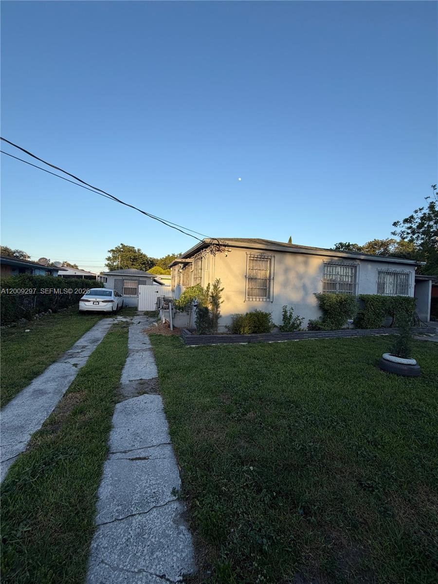 A single-story house with a concrete driveway and security bars on the windows — 6741 NW 6th Ct, Miami FL 33150, MIAMI, FL