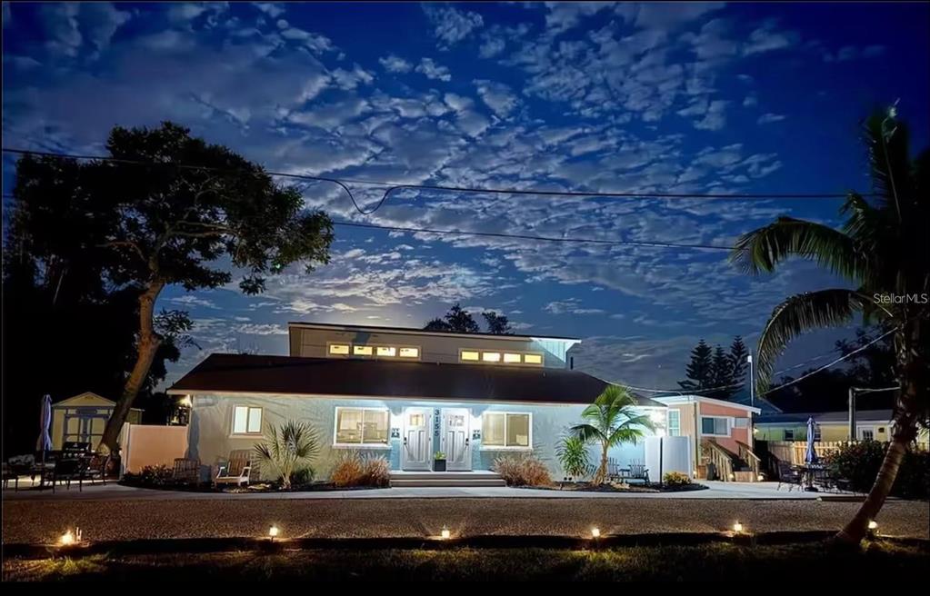 A single-story house with a white exterior, double front doors, and a bright night sky — 3155 WATERSIDE DRIVE, ENGLEWOOD, FL