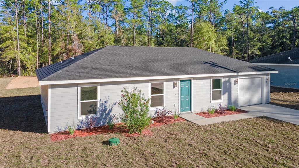 A single-story gray house with a teal front door and a dark shingled roof — 1451 SW 153RD COURT, OCALA, FL