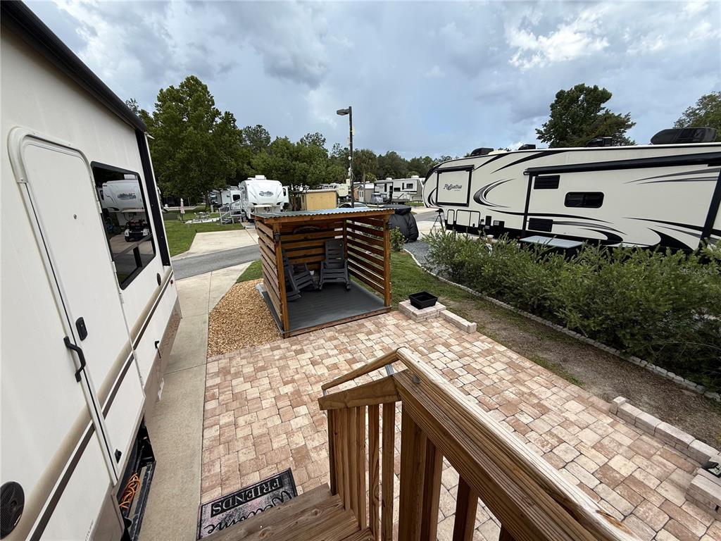 An outdoor patio area features a wooden gazebo, paver flooring, and two parked RVs — 2856 NE 104TH AVENUE, SILVER SPRINGS, FL