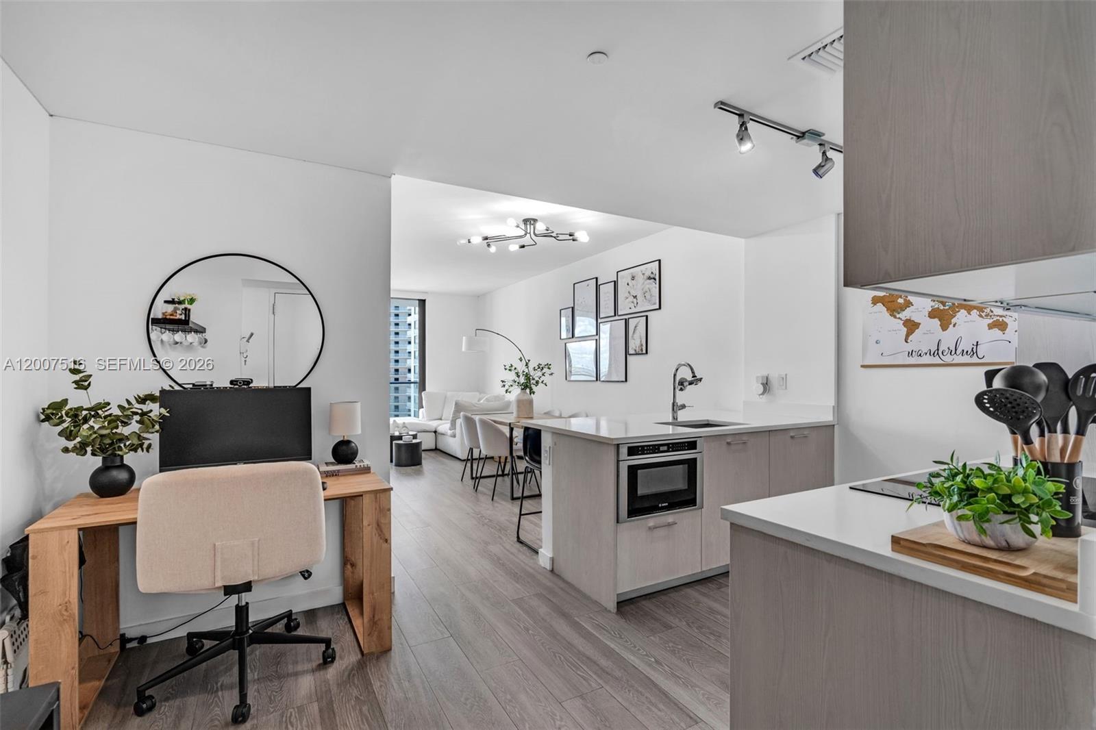 A modern apartment features an open-plan kitchen, dining area, and a home office space — 501 NE 31st St # 3704, Miami FL 33137, MIAMI, FL