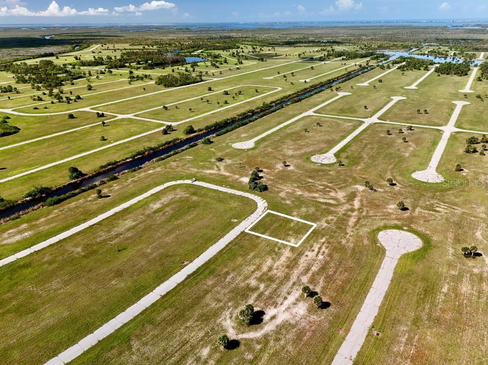 An aerial view shows a vacant residential lot outlined in white within a developed subdivision — 12392 BONITA PLACE, PLACIDA, FL
