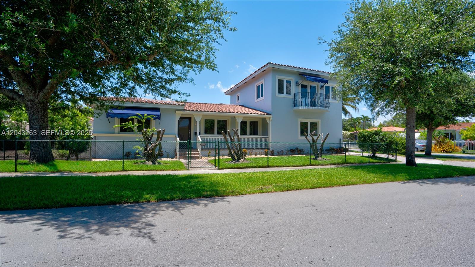 A two-story light blue house with a tiled roof and a fenced front yard — 500 SW 51st Ct # 1, Miami FL 33134, MIAMI, FL