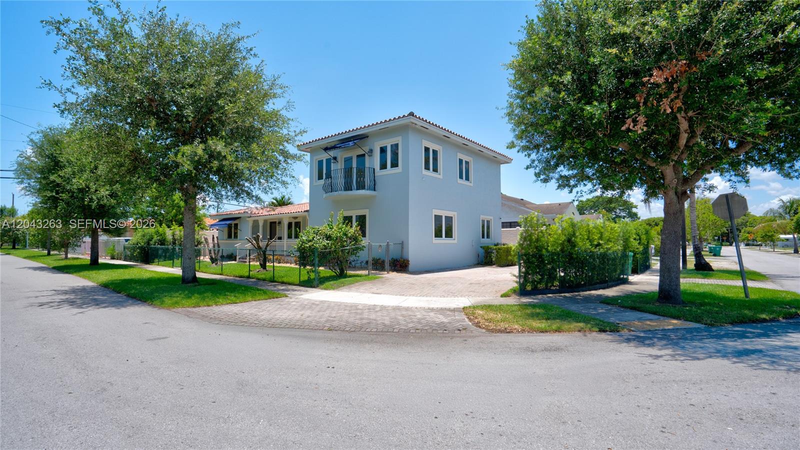 A two-story light blue house with a balcony stands on a corner lot — 500 SW 51st Ct # 1, Miami FL 33134, MIAMI, FL