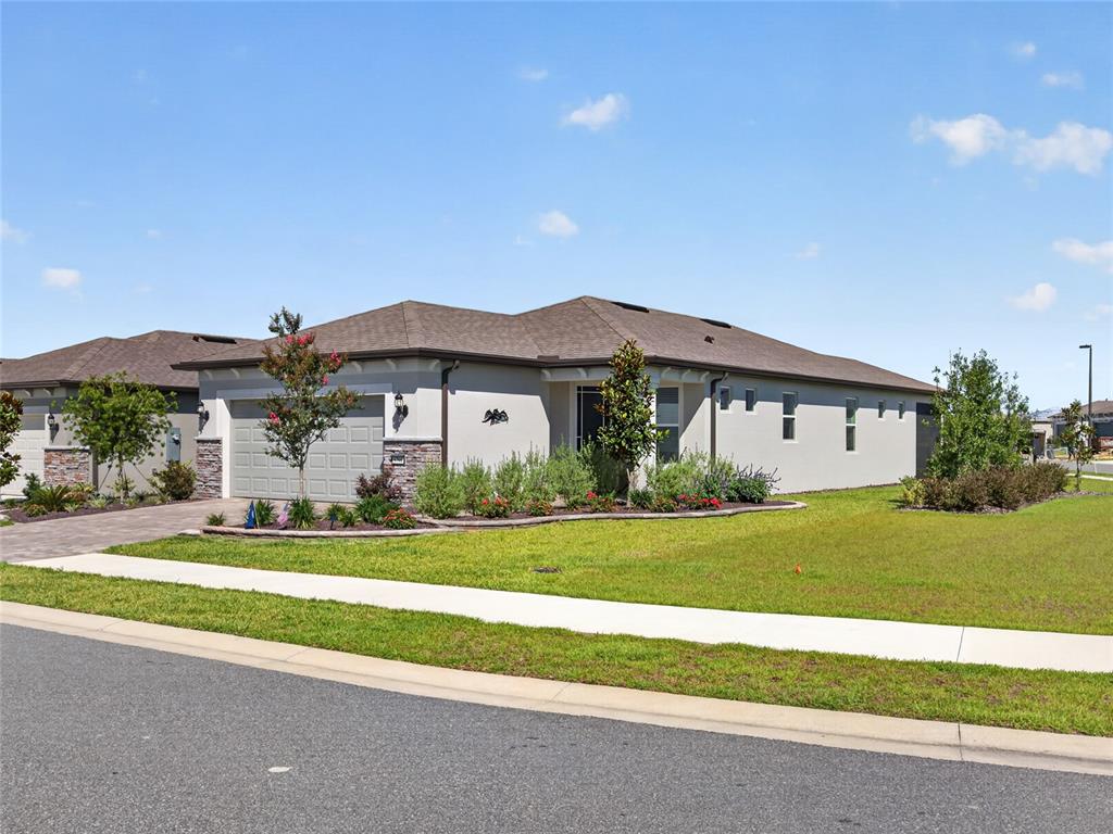 A single-story house with a gray garage, stucco exterior, and a landscaped front yard — 5798 SW 86TH AVENUE ROAD, OCALA, FL