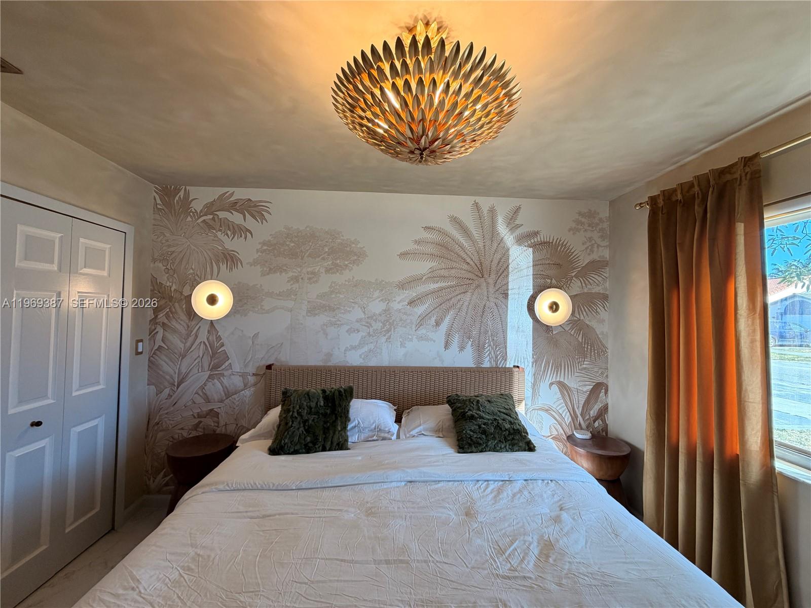 A bedroom features a palm-themed mural, a woven headboard, and a gold leaf-style ceiling fixture — 14617 SW 167th Ter, Miami FL 33177, MIAMI, FL