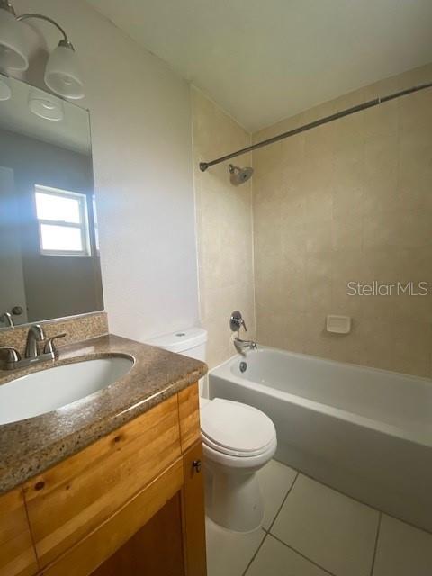 A bathroom features a wooden vanity with a sink, a toilet, and a shower-tub combination — 3914 NEPTUNE STREET UNIT 1, TAMPA, FL