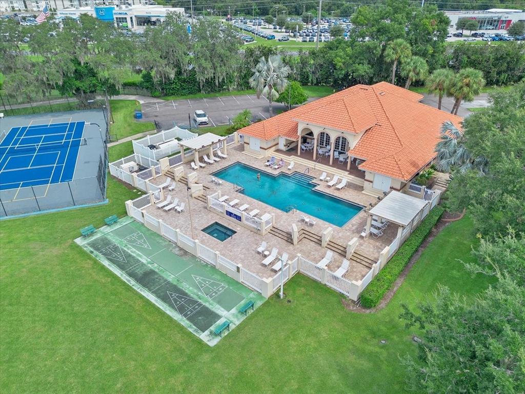 An aerial view shows a community pool area with a clubhouse, tennis court, and shuffleboard courts — 3027 RICHMOND DRIVE, WINTER HAVEN, FL
