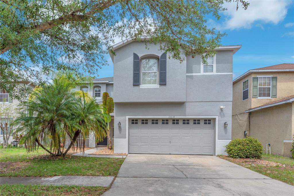 A two-story gray house with a two-car garage and a concrete driveway — 10638 DAWNS LIGHT DRIVE, RIVERVIEW, FL