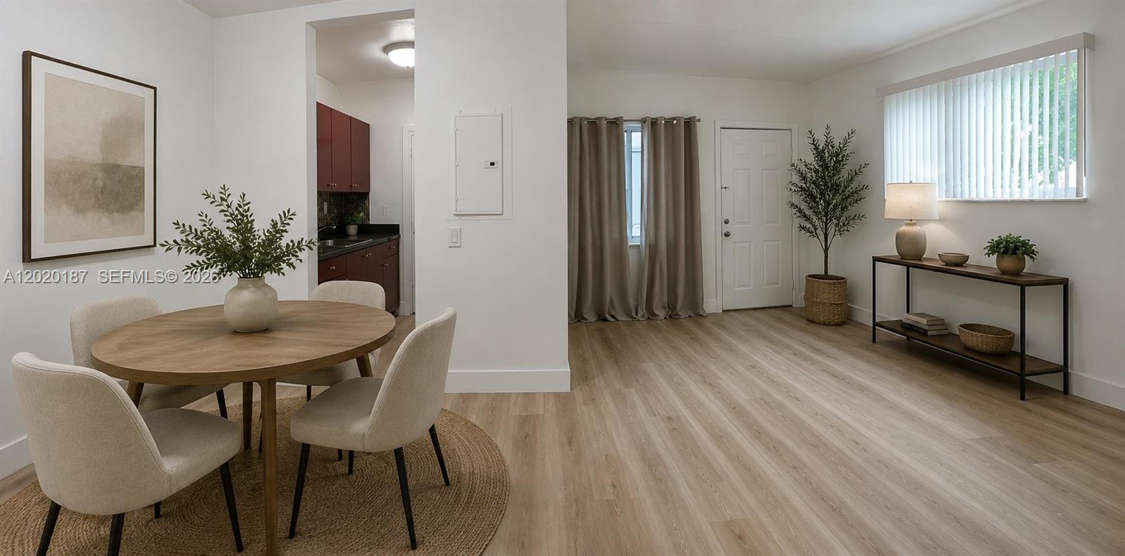 A dining area with a round table and chairs sits adjacent to a kitchen entrance — 791 SW 64th Ave # 4, Miami FL 33144, MIAMI, FL