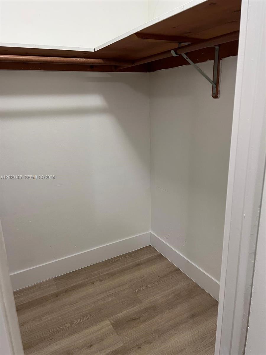 This is a small walk-in closet with wood-look flooring and a single upper shelf — 791 SW 64th Ave # 4, Miami FL 33144, MIAMI, FL