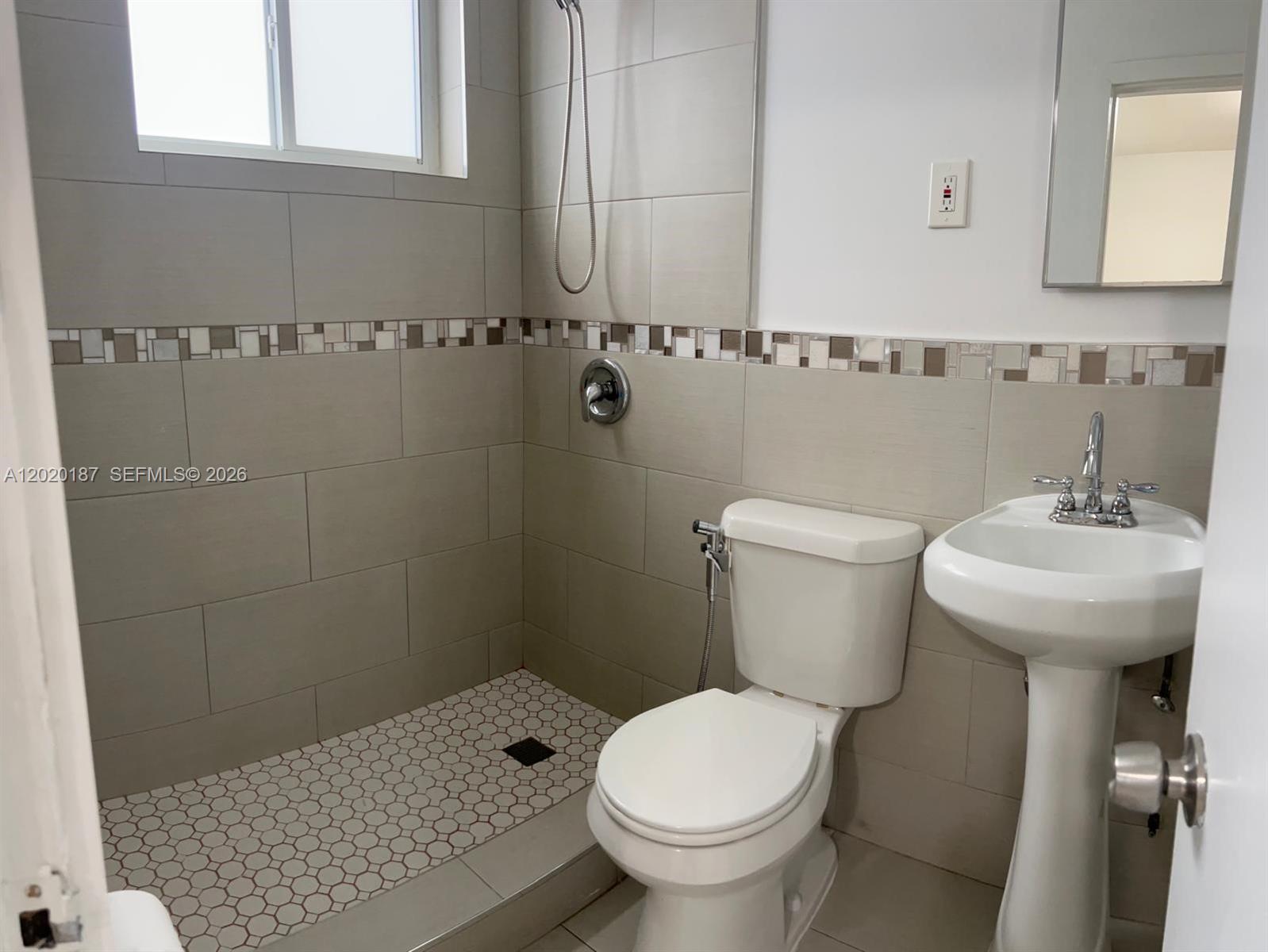 A small bathroom features a walk-in shower, a pedestal sink, and a white toilet — 791 SW 64th Ave # 4, Miami FL 33144, MIAMI, FL