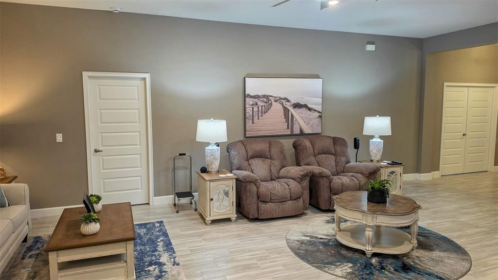 A living room features two brown recliners, two end tables, and a round coffee table — 29 MATRICARIA COURT, HOMOSASSA, FL