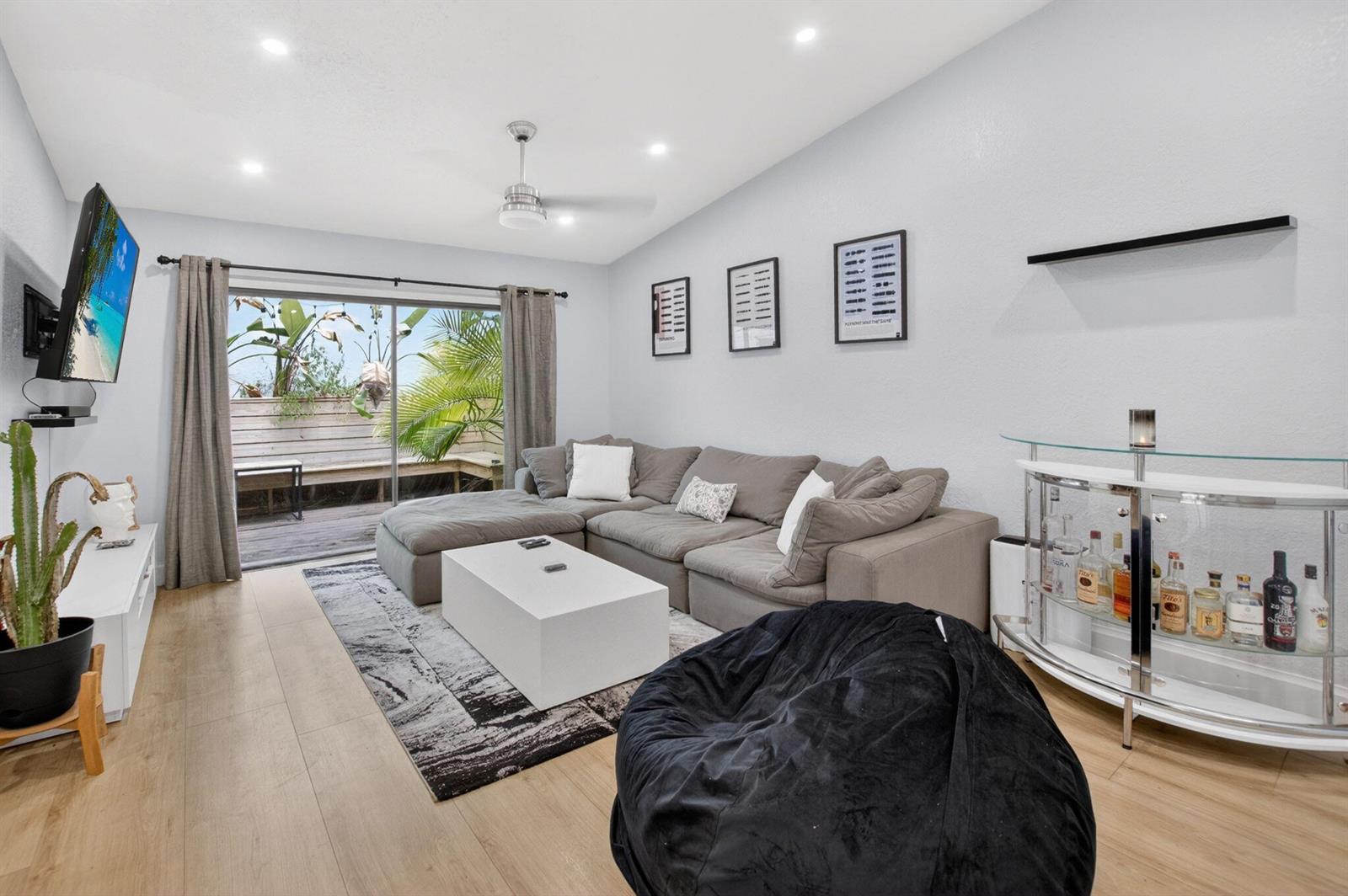 A living room features a gray sectional sofa, a white coffee table, and a glass bar — 22270 Pineapple Walk Drive, Boca Raton FL 33433, BOCA RATON, FL