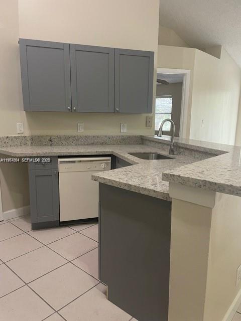 A kitchen features gray cabinets, speckled granite countertops, and a white dishwasher — 9999 Summerbreeze Dr # 1105, Sunrise FL 33322, SUNRISE, FL