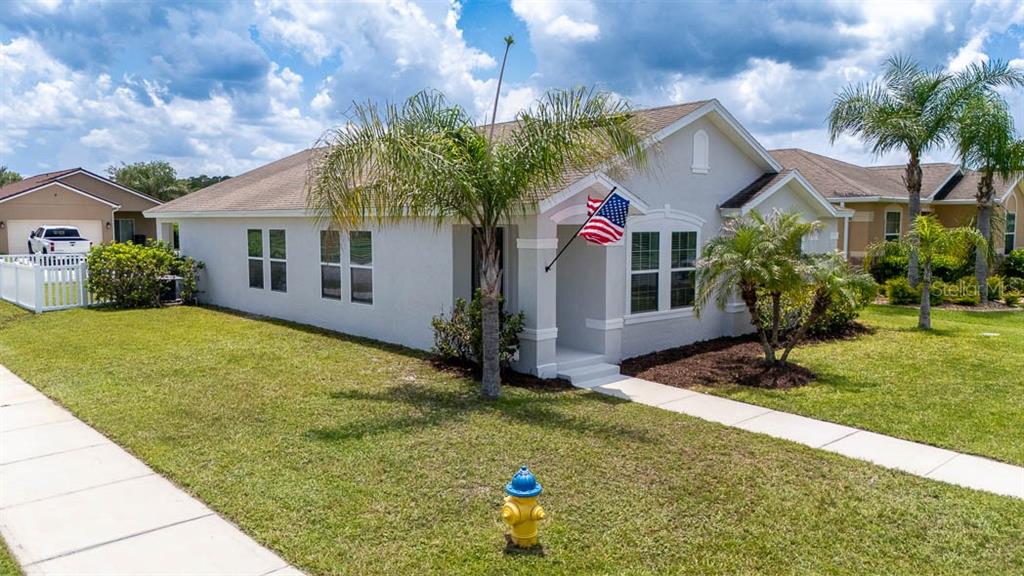 A single-story house with a light-colored exterior, a front porch, and a yellow fire hydrant — 3320 MARSILI AVENUE, NEW SMYRNA BEACH, FL