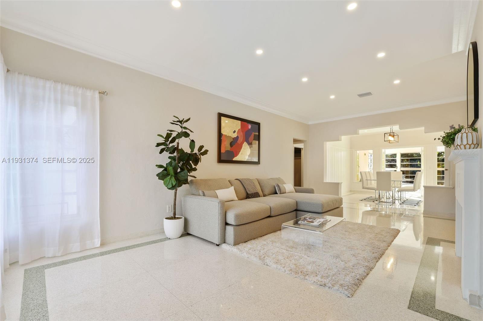 A living room features a beige sectional sofa, a glass coffee table, and tile flooring — 3760 Royal Palm Ave, Miami Beach FL 33140, MIAMI BEACH, FL