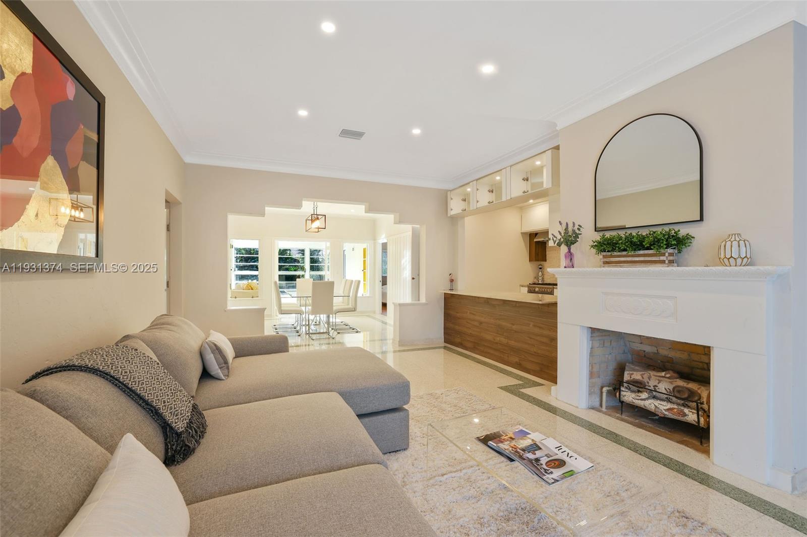 A living room features a grey sectional sofa, a fireplace, and an adjacent dining area — 3760 Royal Palm Ave, Miami Beach FL 33140, MIAMI BEACH, FL